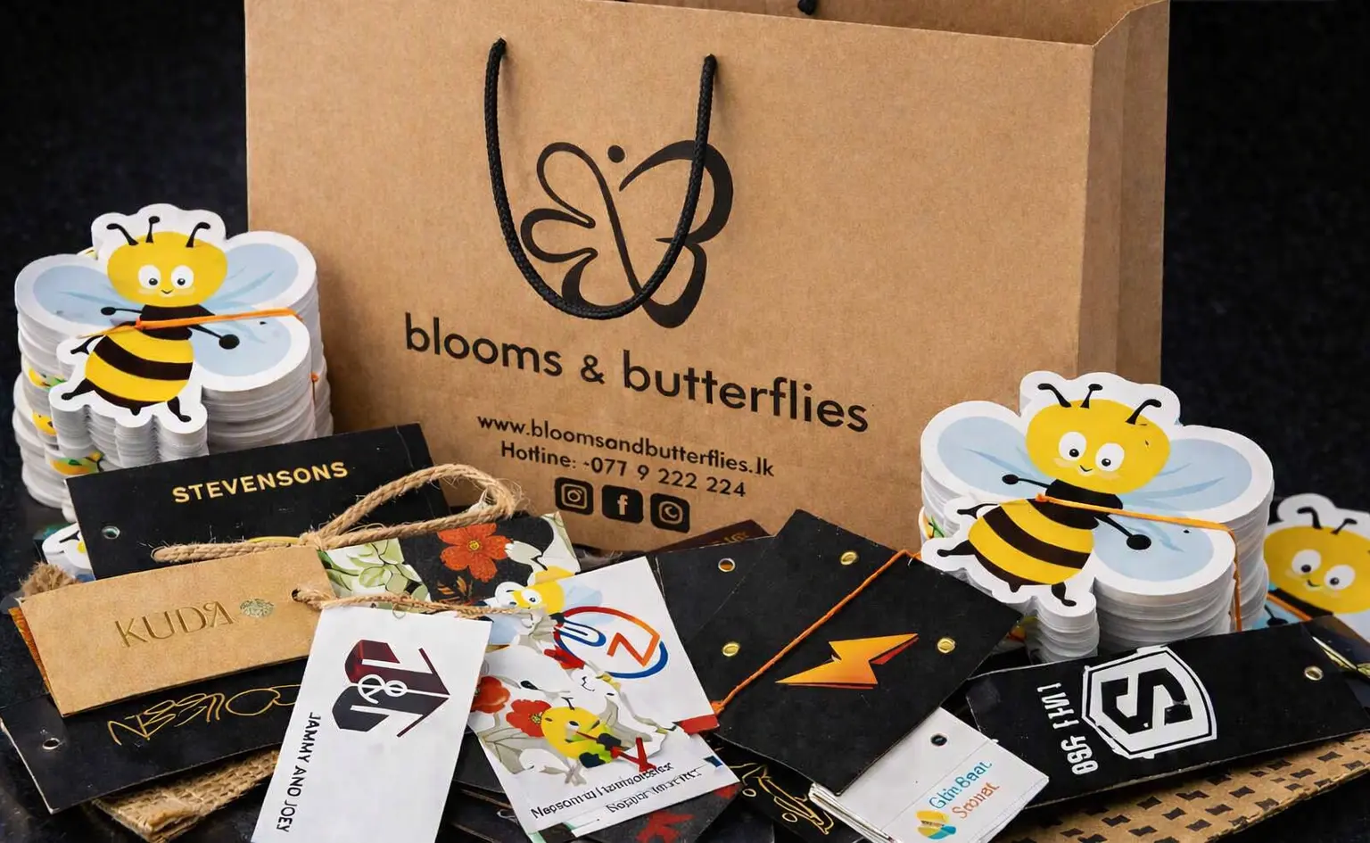 Assorted printed products including barcode stickers, hang tags, and poly bags
